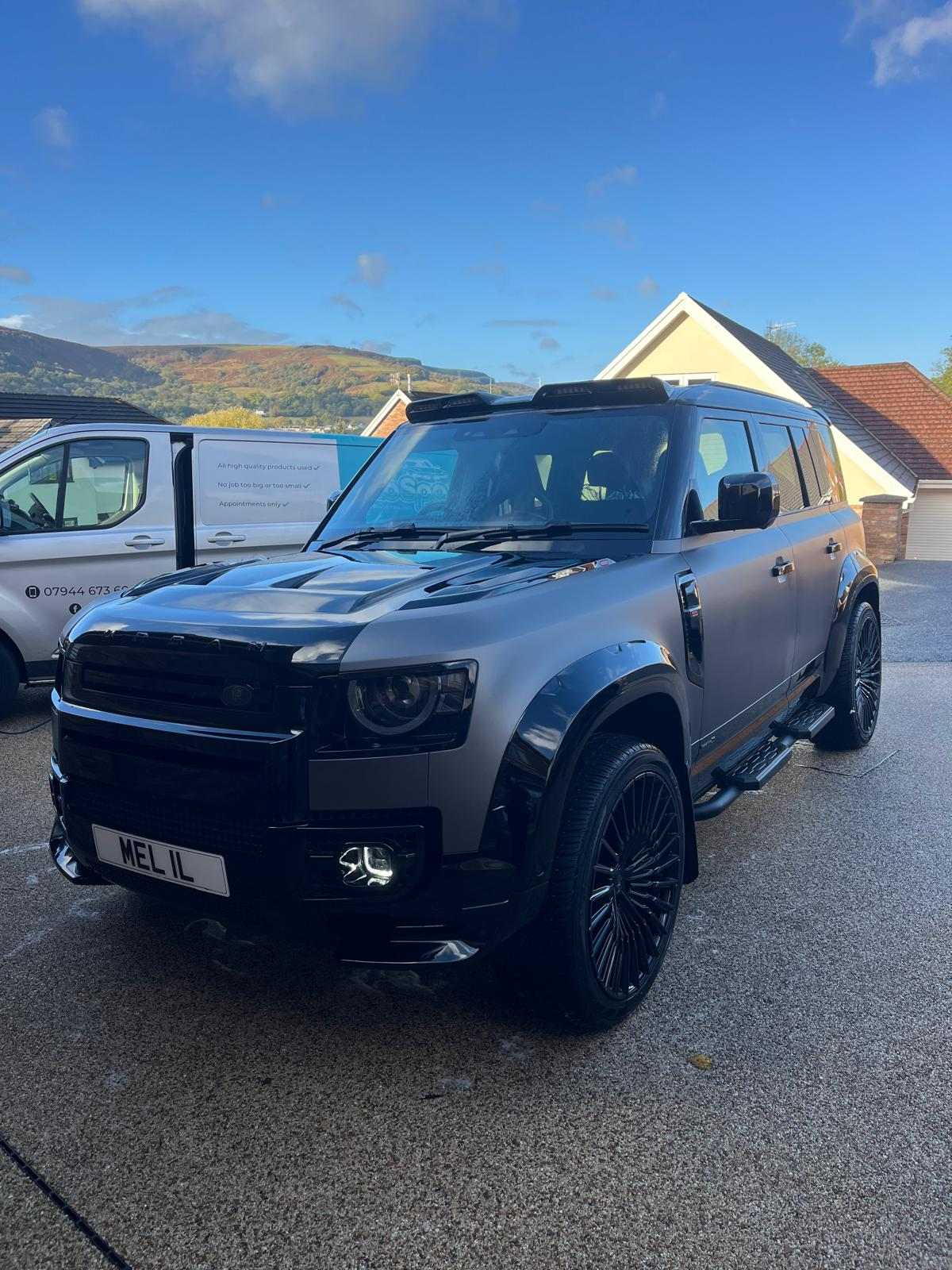 Urban-styled Land Rover Defender protected with a ceramic coating by The Auto Spa, alongside the mobile detailing van in Aberdare